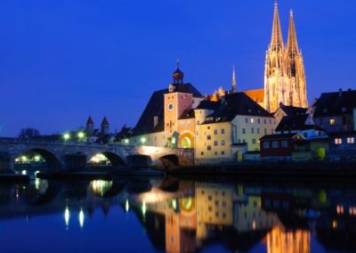 View at stone bridge and Regensburg cathedral by night