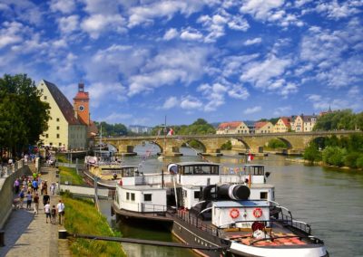 Ships on the Danube harbour with view to stone bridge