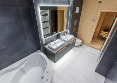 Bathroom with sauna and whirlpool bathtub