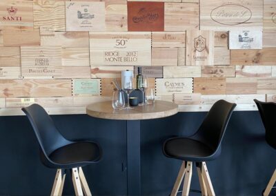 Table in restaurant with wine box covers at wall